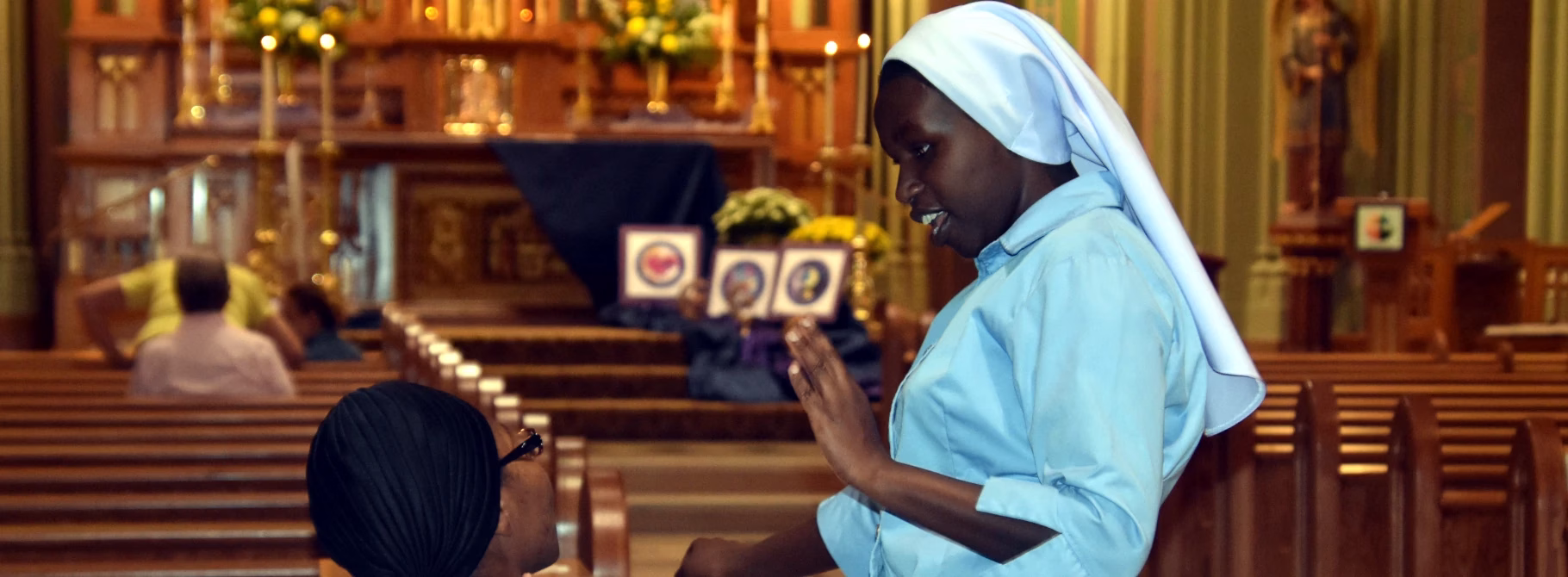 Ancilla Domini Chapel Sisters engage in conversation in the nave of the chapel while waiting for Mass to begin